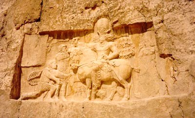 A bas relief of Emperor Valerian standing at the background and held captive by Shapur I found at Naghsh-e Rostam, Shiraz, Iran. The kneeling man is probably Philip the Arab.